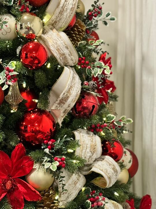 Red ornaments and ivory ribbon close-up