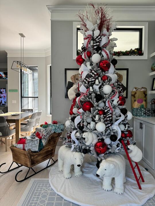 Flocked tree in red, white and black with a red ladder and polar bears