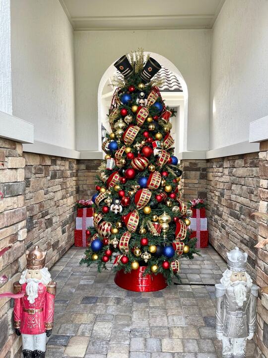 Nutcracker tree between stone walls with nutcracker figures